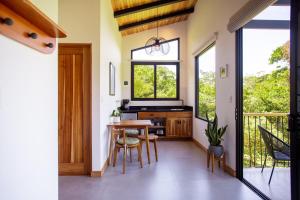 a kitchen with a table and chairs and a window at MAUMA Forest Villas - Fireplace & Amazing Views in Monteverde Costa Rica +33 photos