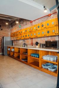 a kitchen with wooden cabinets and a brick wall at Bodegante CoLiving in León