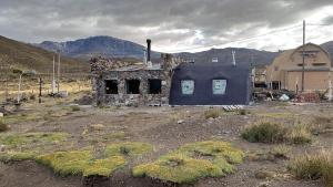 an old stone house in the middle of a field at Cabaña Los Molles in Malargüe