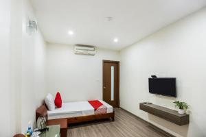 a bedroom with a bed and a tv on a wall at Nha Khach Giao Thong in Hanoi +17 photos