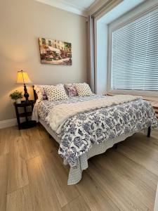 a bedroom with a large bed with a window at Home sweet home in Richmond