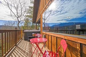 a red table on a deck with a grill at Great View Location Studio Log Cabin Hot Tub in Gatlinburg
