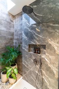 a shower in a bathroom with plants at Jago Gili Air in Gili Air