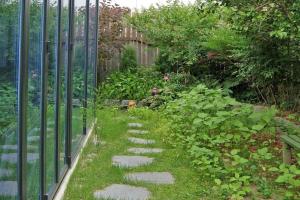 a garden with a fence and a walkway at Tasha's Garden Private Pension Jeonju Hanok Village in Jeonju +7 photos
