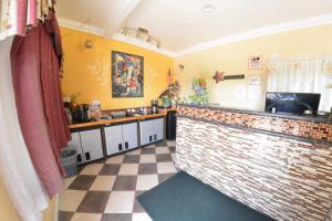 a kitchen with a brick counter and a tile floor at The Palace Inn in Oxnard