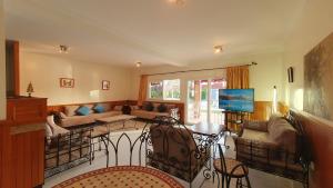a living room with a couch and a table at L'oasis d'Agadir - Agadir's hidden Oasis in Agadir