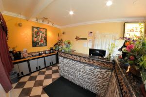 a kitchen with a bar with a checkered floor at The Palace Inn in Oxnard