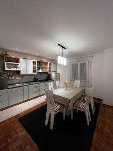 a kitchen with a table and chairs in a room at Apartman Nada in Biograd na Moru