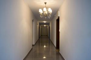 a corridor in a building with a chandelier at Byala Home Apartment Complex in Byala