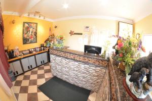 a bar in a room with a checkered floor at The Palace Inn in Oxnard