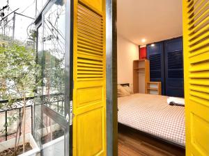 a small bedroom with a bed and a window at Ding Doong Homes in Hanoi