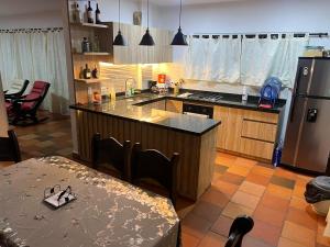a kitchen with a refrigerator and a table with chairs at Parcela villa David mesa de los santos in Piedecuesta