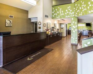 a lobby of a hotel with a counter and a restaurant at Sleep Inn South Joplin in Joplin