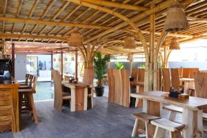 a dining room with wooden tables and chairs at Aqua Dive resort Amed in Amed