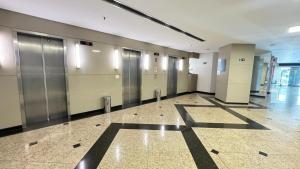 a row of elevators in a hallway in a building at Hotel & Residence Sol Alphaville Flat in Barueri