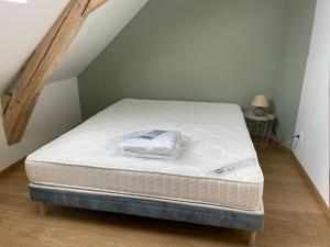 un materasso appoggiato in una stanza con soffitta di Gîte de charme près du Mans pour 4 avec piscine naturelle - FR-1-410-473 a Teloché