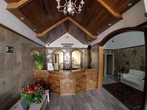 a large living room with a chandelier and a living room at Apartamentos Tapahuga in Playa de Santiago +26 photos