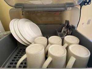 a bunch of white plates and dishes in a refrigerator at Roy Lao House in Khao Lak