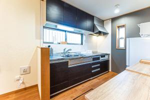 a kitchen with a sink and a refrigerator at Third Place Tokyo - Aoto - in Tokyo +28 photos