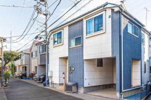 a blue and white building on a street at Third Place Tokyo - Aoto - in Tokyo