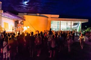 a crowd of people looking at a stage in front of a building at Apartment in Rosolina Mare 49216 in Rosolina Mare
