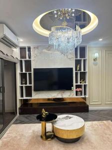 a living room with a chandelier and a coffee table at SEE TRAVEL - Tecco Elite city Thai Nguyen 