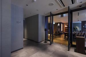 a room with a dining room and a dining table at GRIDS PREMIUM HOTEL OSAKA NAMBA in Osaka