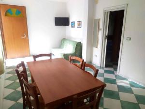 a dining room with a wooden table and chairs at Holiday Homes in Rosolina Mare 48310 in Rosolina Mare