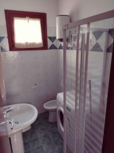 a bathroom with a toilet and a sink at Holiday Homes in Rosolina Mare 48310 in Rosolina Mare