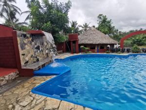 a pool at a resort with a water slide at Cabañas LOS REYES in San Pedro Pochutla