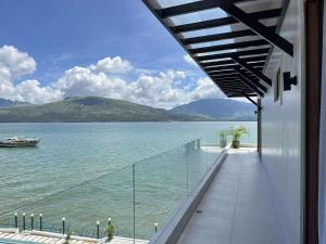 a balcony with a view of a body of water at Costa Del Subic in Subic
