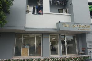 a building with a sign that reads ski outpost at V Home Apartment in Ban Chek