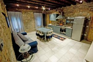 a kitchen with a blue couch and a table at Aiceltis in Teolo