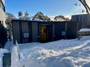 a building with a lot of snow in front of it at Alpina Apartment 1 in Falls Creek