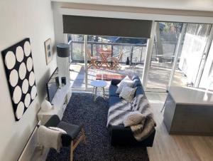 a living room with a couch and a table at Alpina Apartment 1 in Falls Creek