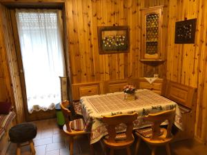 a dining room with a table and some chairs at Casa Solidea in Moena +9 photos