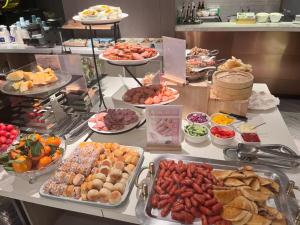 a buffet with many different types of food on a table at Atour Light Harbin Central Street in Harbin +40 photos