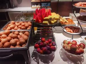 a buffet filled with different types of fruits and vegetables at Atour Light Harbin Central Street in Harbin
