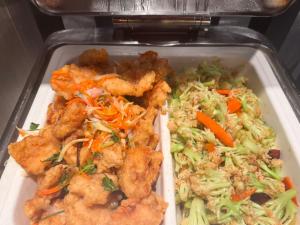 a styrofoam container of food with chicken and vegetables at Atour Light Harbin Central Street in Harbin