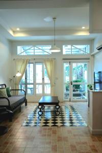a living room with a couch and a coffee table at Spacious 2 Bedroom House In City Centre in Hua Hin