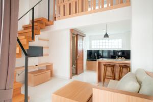 a kitchen and living room with a staircase in a house at Aspen bali nusa dua in Nusa Dua