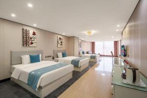 Postel nebo postele na pokoji v ubytování Aksu Pudong Holiday Hotel + 219 fotografií