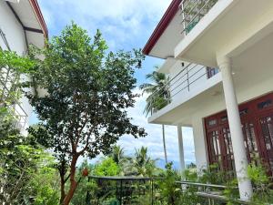 a house with a tree in front of it at Sonora in Kandy