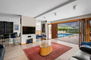 a living room with a view of a pool at Macpherson Street, Wanaka in Wanaka