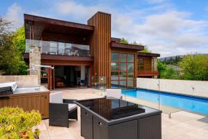 a house with a swimming pool and a house at Macpherson Street, Wanaka in Wanaka