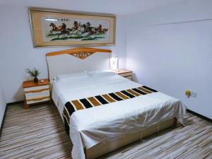 Ein Bett oder Betten in einem Zimmer der Unterkunft Guangzhou City Center Apartment