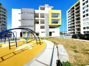 a playground in a city with tall buildings at Bonito Aparatemnto con Piscina in Santa Marta