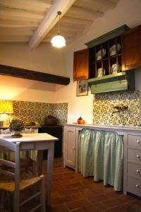 a kitchen with a table and a counter top at Villa Organi in Vaiano