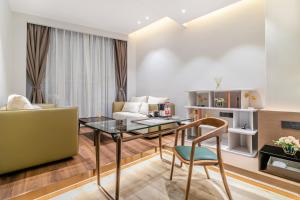 a living room with a table and a couch at Huiju Hotel -Shamian Xidi Pier Night Cruise on the Pearl River branch--Canton Fair free shuttle bus included Breakfast in Guangzhou