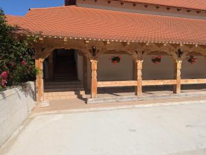 a wooden gazebo with a red tile roof at Vila Bârsana in Bîrsana
